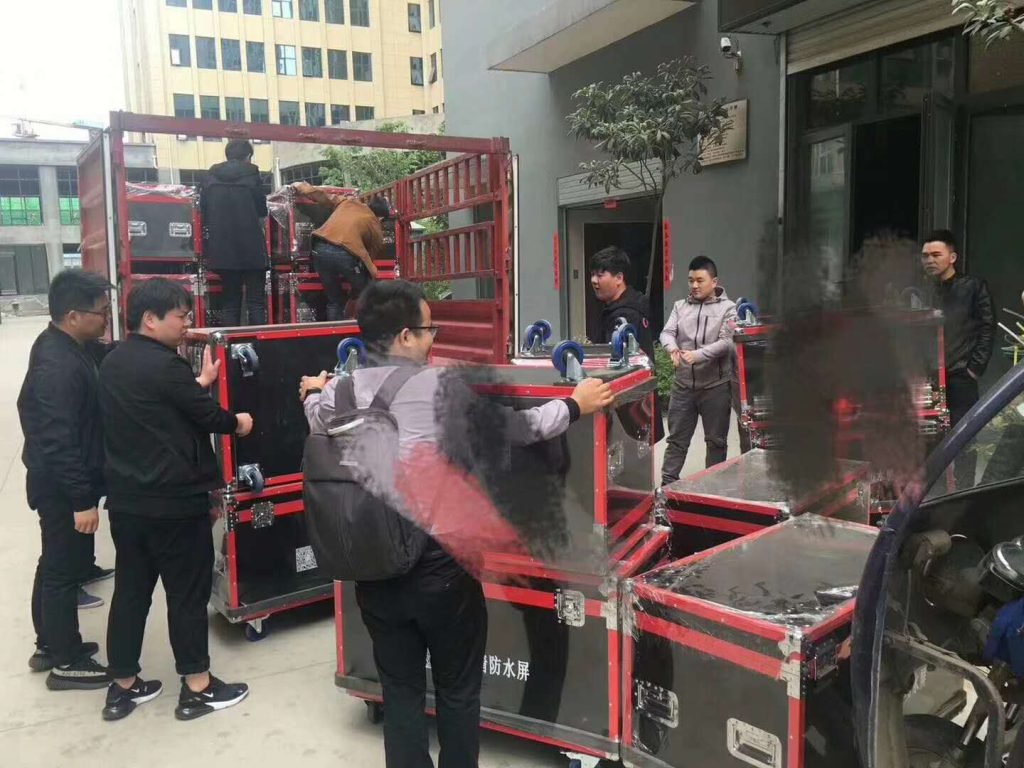 Teams unloading cases for controlled handling