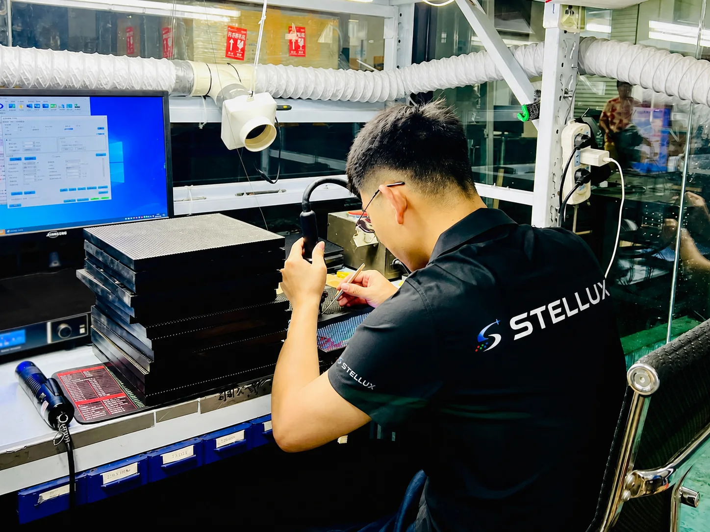 Stellux technician repairing LED modules at a workbench