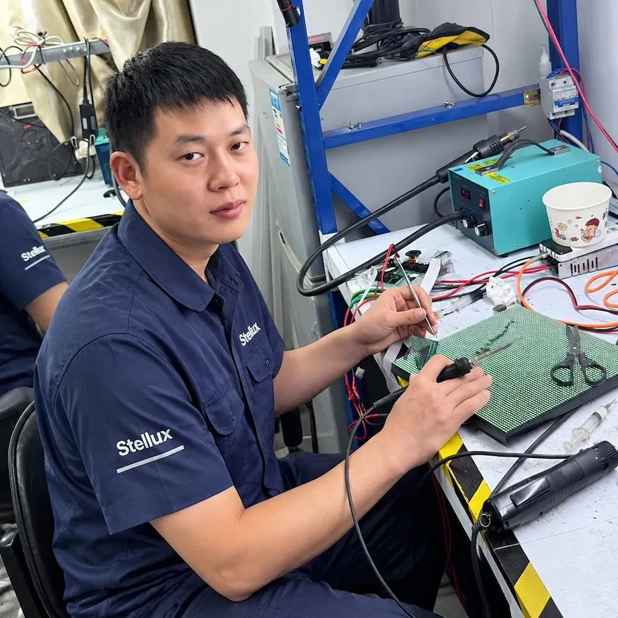 Stellux technician performing precision LED module solder and driver repair on the refurbishment bench